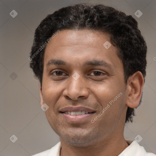 Joyful latino adult male with short  brown hair and brown eyes