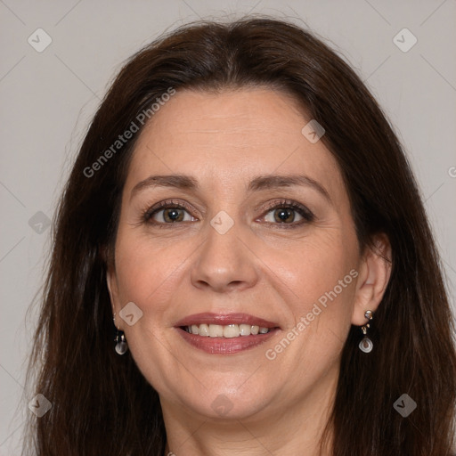 Joyful white adult female with long  brown hair and brown eyes