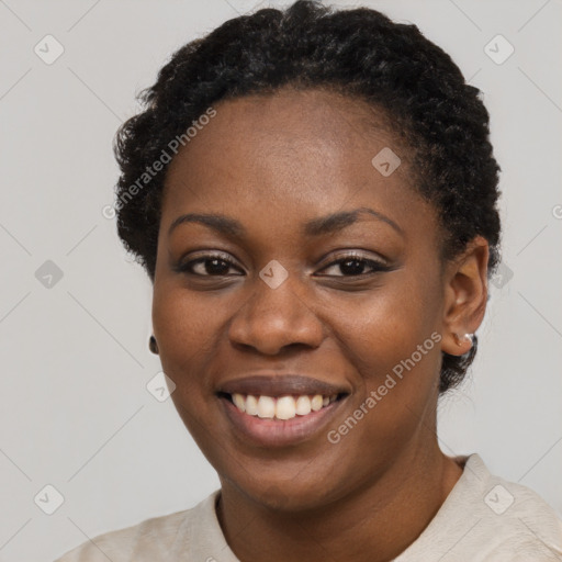 Joyful black young-adult female with short  black hair and brown eyes