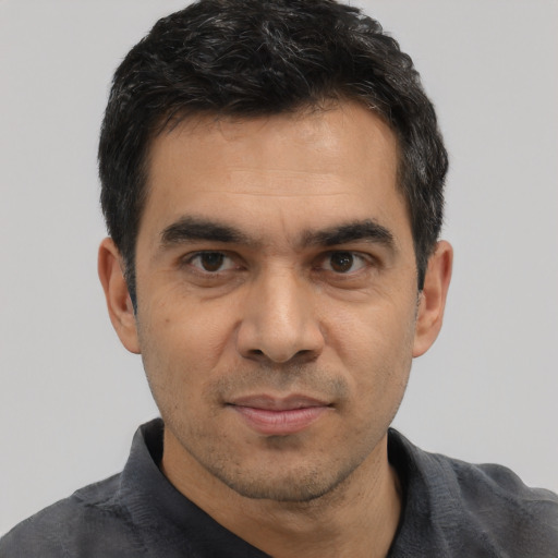 Joyful asian adult male with short  black hair and brown eyes