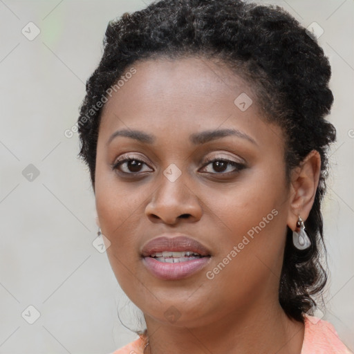 Joyful black young-adult female with long  black hair and brown eyes
