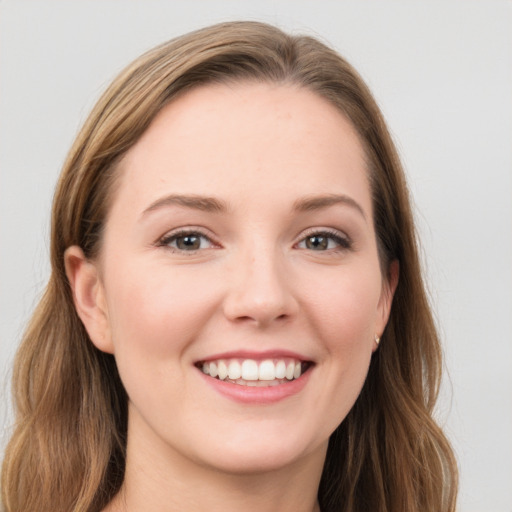 Joyful white young-adult female with long  brown hair and blue eyes