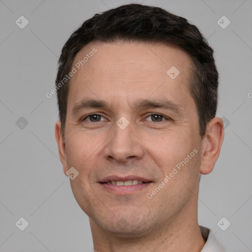 Joyful white adult male with short  brown hair and brown eyes