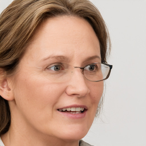 Joyful white adult female with medium  brown hair and blue eyes