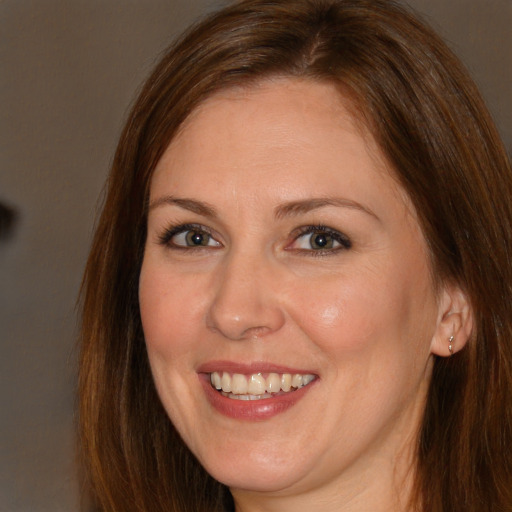 Joyful white adult female with long  brown hair and brown eyes