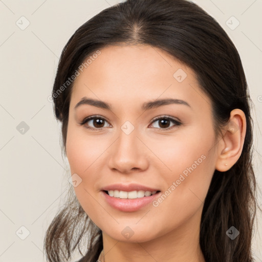 Joyful white young-adult female with long  brown hair and brown eyes