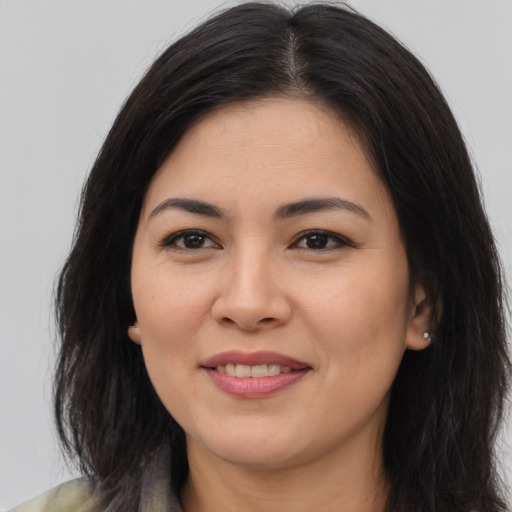 Joyful asian young-adult female with long  brown hair and brown eyes