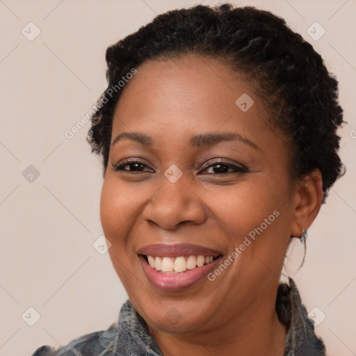 Joyful black adult female with short  brown hair and brown eyes