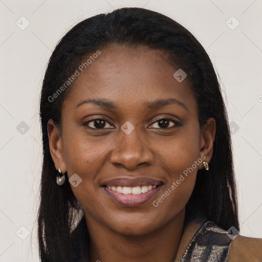 Joyful black young-adult female with long  brown hair and brown eyes