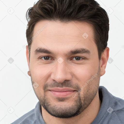 Joyful white young-adult male with short  brown hair and brown eyes