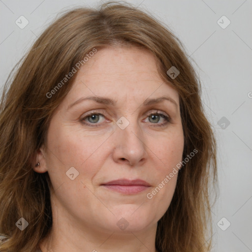 Joyful white adult female with long  brown hair and green eyes