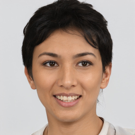 Joyful latino young-adult female with short  brown hair and brown eyes