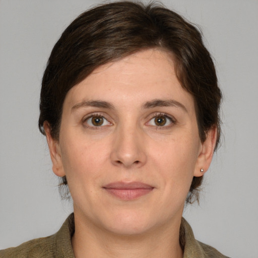 Joyful white adult female with medium  brown hair and grey eyes