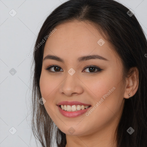 Joyful asian young-adult female with long  brown hair and brown eyes