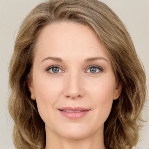 Joyful white young-adult female with medium  brown hair and green eyes