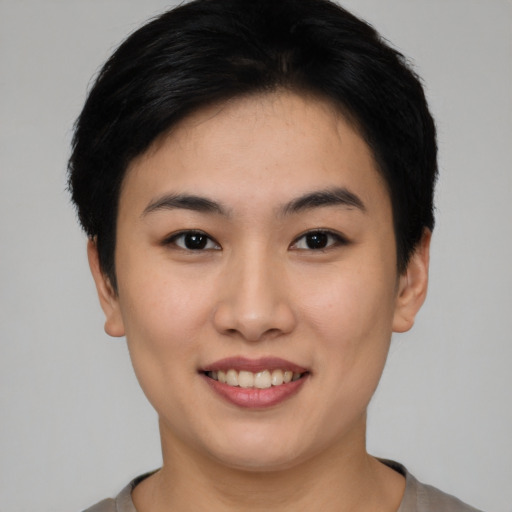 Joyful asian young-adult female with short  black hair and brown eyes