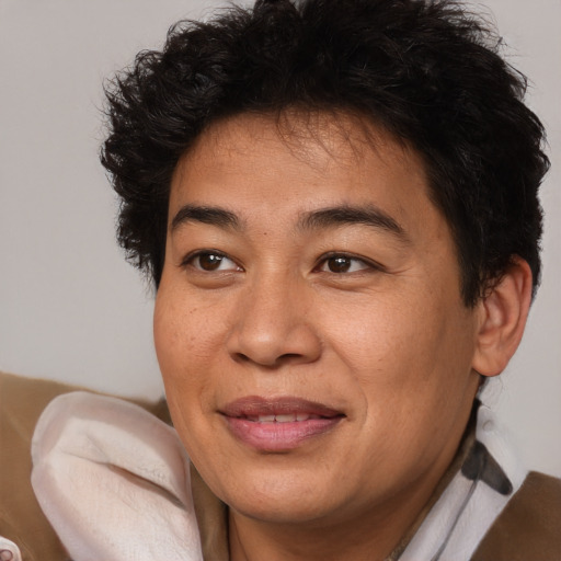 Joyful black adult male with short  brown hair and brown eyes