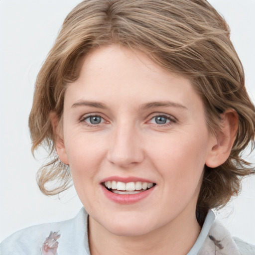 Joyful white young-adult female with medium  brown hair and blue eyes