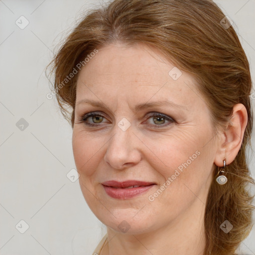 Joyful white adult female with long  brown hair and brown eyes