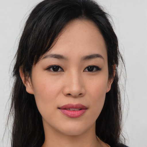 Joyful asian young-adult female with long  brown hair and brown eyes