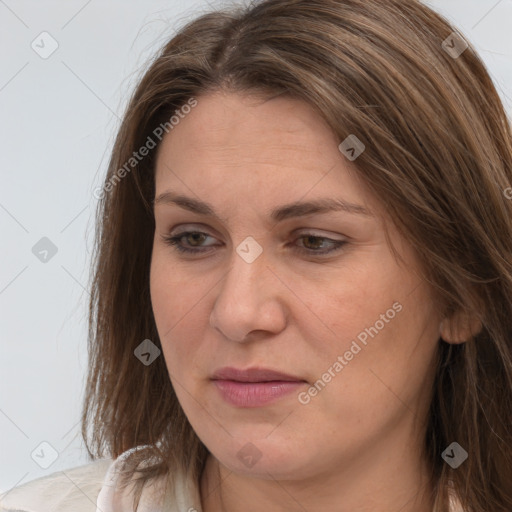 Joyful white adult female with long  brown hair and brown eyes