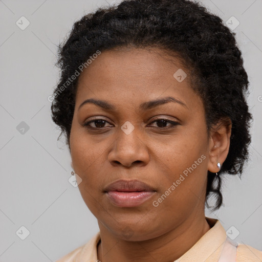 Joyful black adult female with short  brown hair and brown eyes