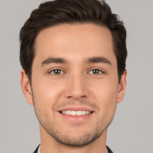 Joyful white young-adult male with short  brown hair and brown eyes