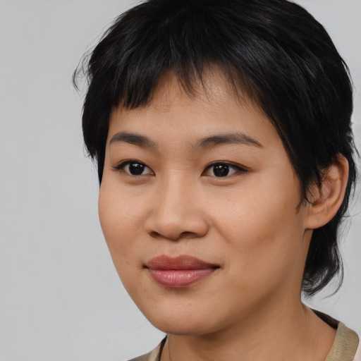 Joyful latino young-adult female with medium  black hair and brown eyes