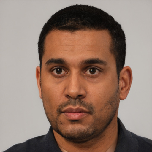Neutral latino young-adult male with short  black hair and brown eyes