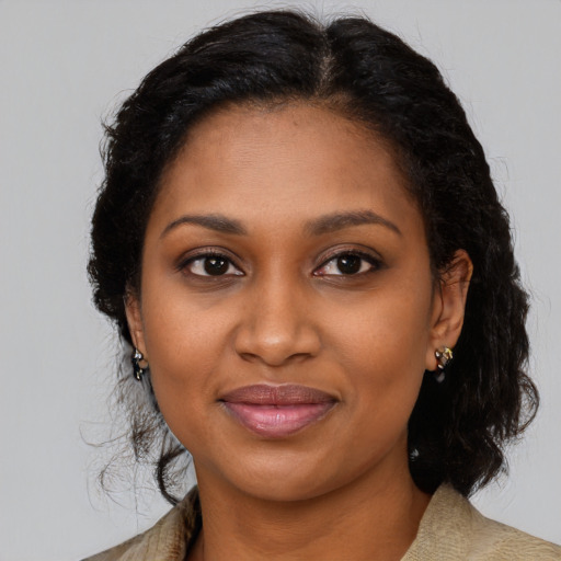 Joyful black young-adult female with medium  brown hair and brown eyes