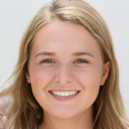 Joyful white young-adult female with long  brown hair and blue eyes