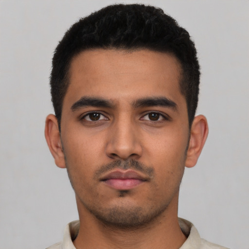 Neutral latino young-adult male with short  black hair and brown eyes