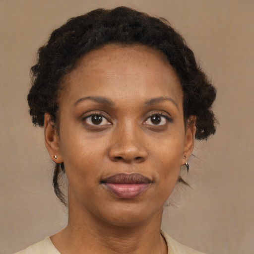 Joyful black adult female with short  brown hair and brown eyes