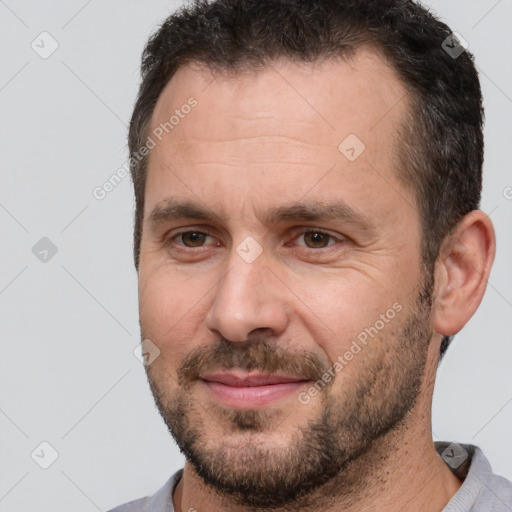 Joyful white adult male with short  brown hair and brown eyes