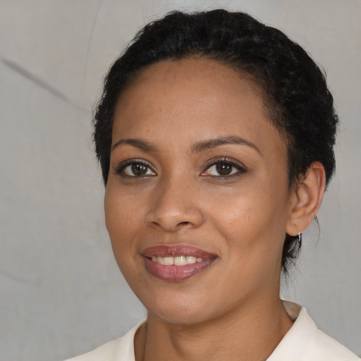 Joyful white young-adult female with short  black hair and brown eyes