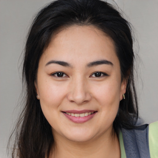 Joyful asian young-adult female with long  brown hair and brown eyes