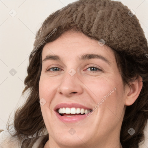 Joyful white young-adult female with medium  brown hair and green eyes