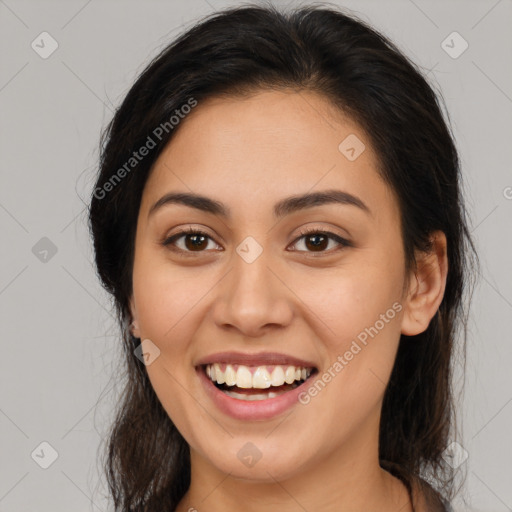 Joyful latino young-adult female with long  brown hair and brown eyes