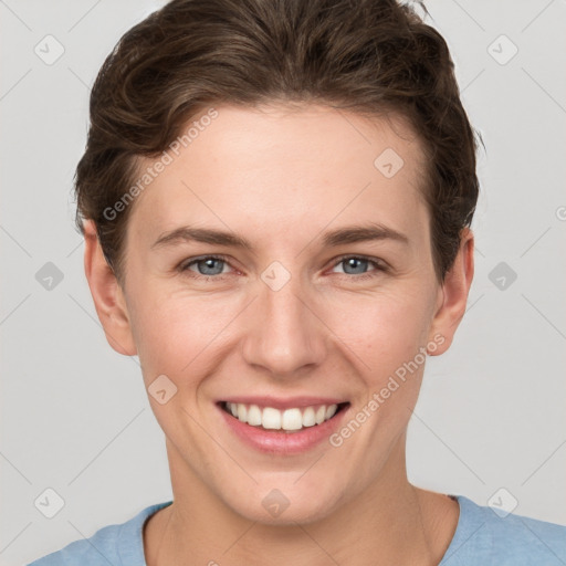 Joyful white young-adult female with short  brown hair and grey eyes