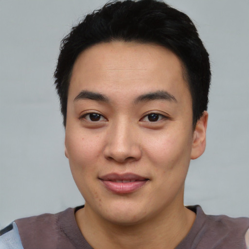 Joyful asian young-adult male with short  black hair and brown eyes