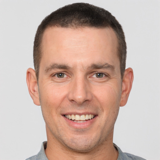 Joyful white adult male with short  brown hair and brown eyes