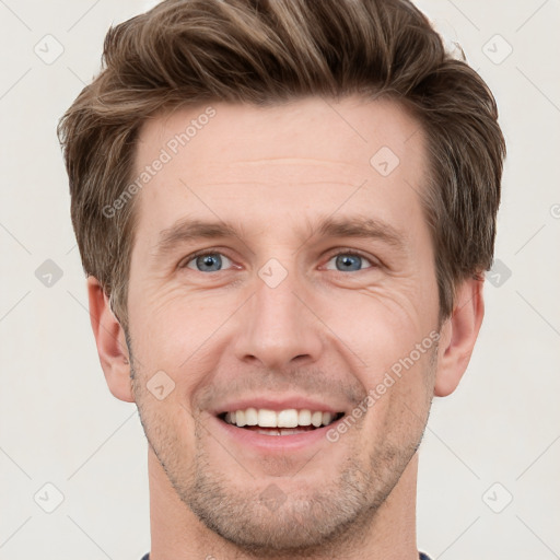 Joyful white adult male with short  brown hair and grey eyes