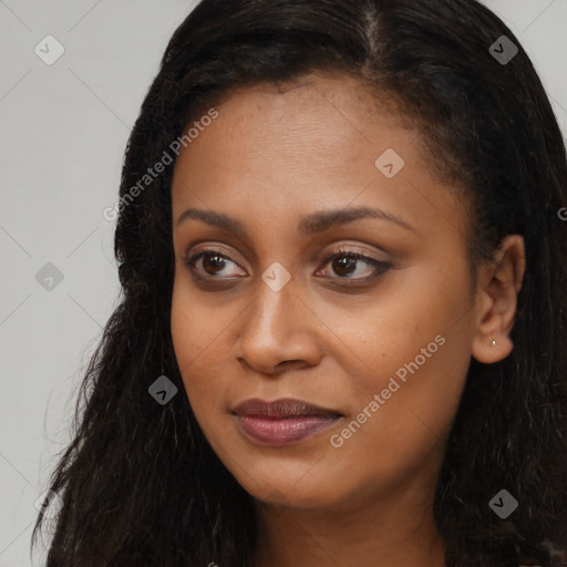 Joyful black young-adult female with long  brown hair and brown eyes