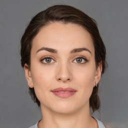 Joyful white young-adult female with medium  brown hair and brown eyes