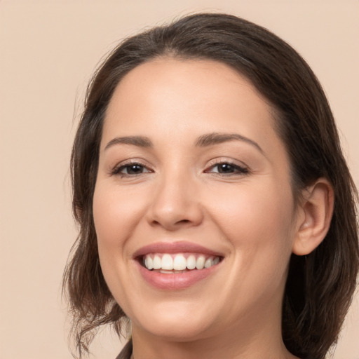 Joyful white young-adult female with medium  brown hair and brown eyes