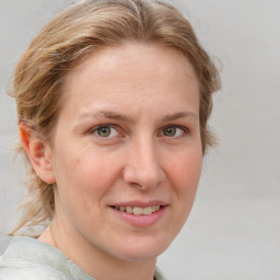 Joyful white adult female with medium  brown hair and blue eyes