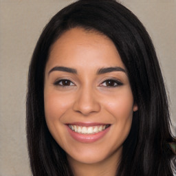 Joyful latino young-adult female with long  black hair and brown eyes