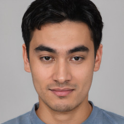 Joyful asian young-adult male with short  black hair and brown eyes