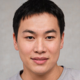 Joyful asian young-adult male with short  brown hair and brown eyes