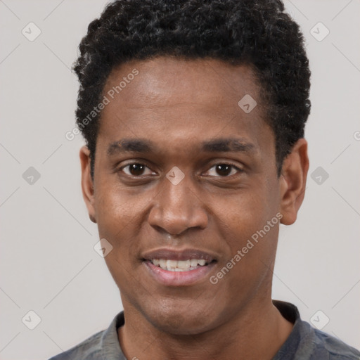 Joyful black young-adult male with short  black hair and brown eyes